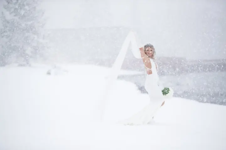 A bride on the snow-covered lawn in winter