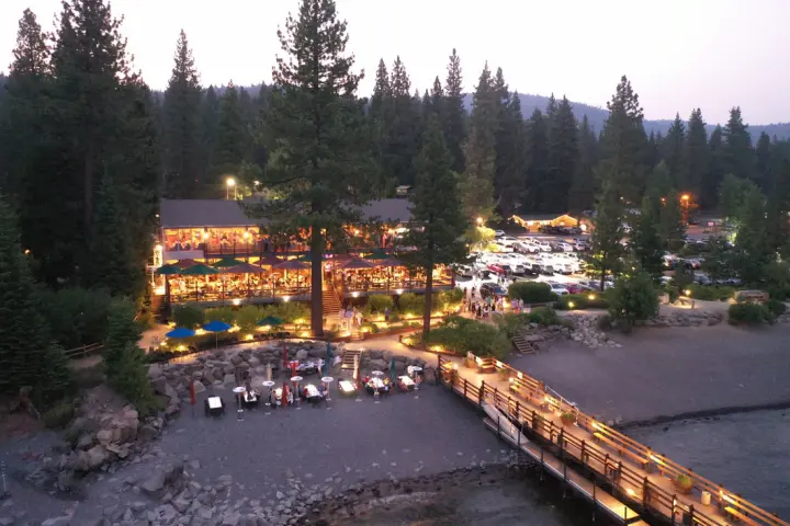 Gar Woods lit up at dusk above Carnelian Bay, the pier reaching into the lake