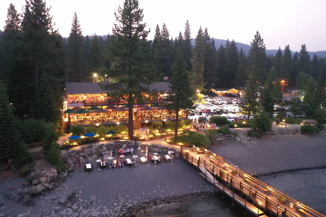 Gar Woods Grill & Pier lit up at dusk above Carnelian Bay, with the pier reaching into Lake Tahoe