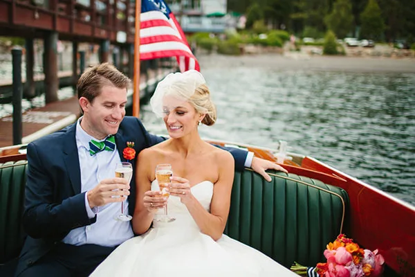 A couple aboard a classic wooden boat on Lake Tahoe