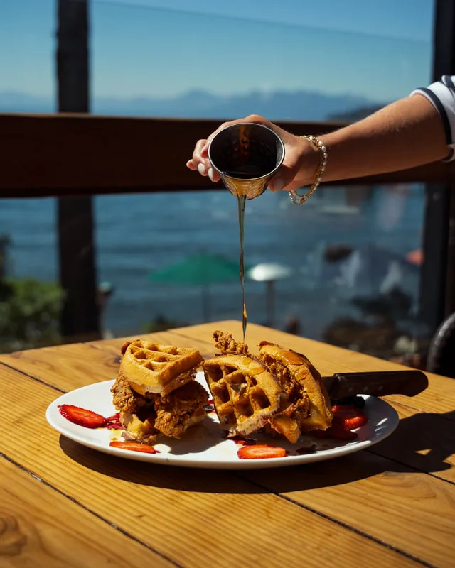 A dish being finished tableside above the lake