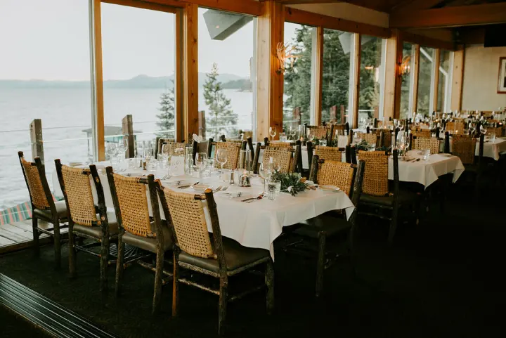 The dining room, tables set along floor-to-ceiling windows